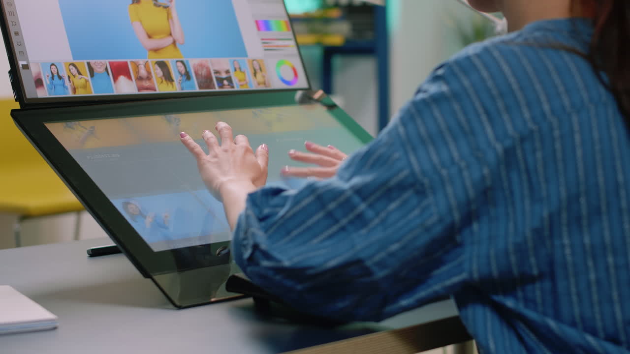Close up of photographer hands using touch screen monitor