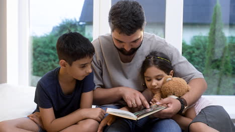 father, son and daughter in the living room.