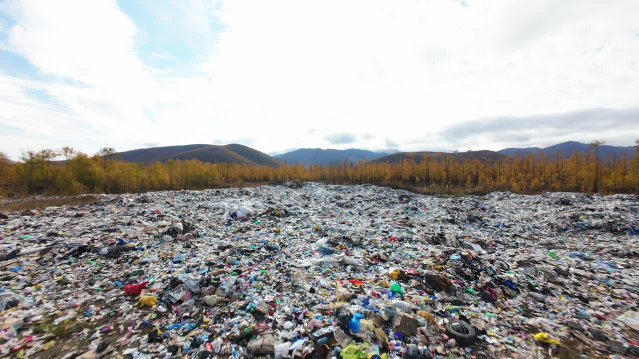 This location reveals a sprawling dump filled with discarded household items, set against a backdrop of nature. It highlights the impact of waste on our environment and calls for action.