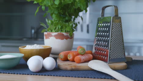 ingredients for making carrot cake ready on the kitchen table