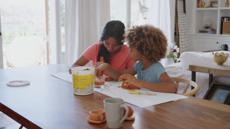 close up of two pre-teen girlfriends having fun playing with modelling clay at home