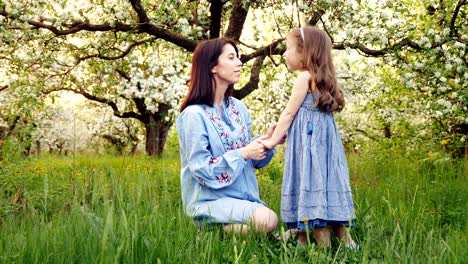 mother and child are hugging and having fun outdoor in nature