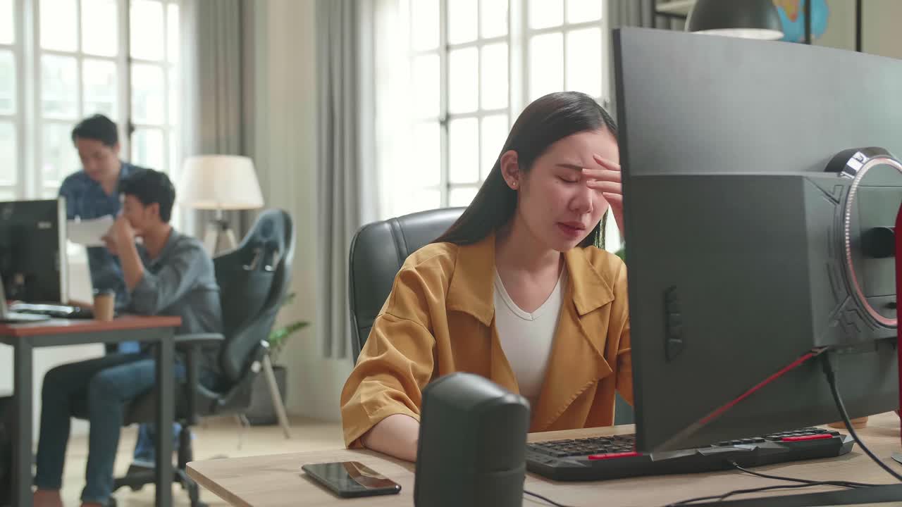 Frustrated Asian Female Works Her Personal Computer In Office
