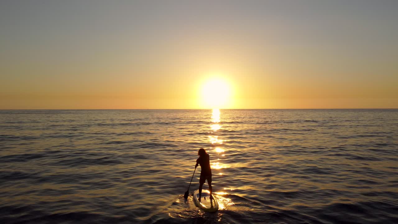 Silhouette Of Surfer Enjoy Standup Paddleboarding In The Ocean During Sunset In Batroun, Lebanon. - aerial