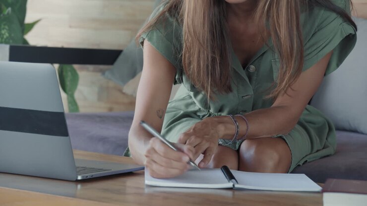 Smart Woman Writing in Notebook