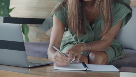 smart woman writing in notebook