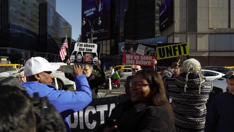 as the sunlight pours down, protesters gather around madison square garden, their calls for change growing louder in opposition to trump