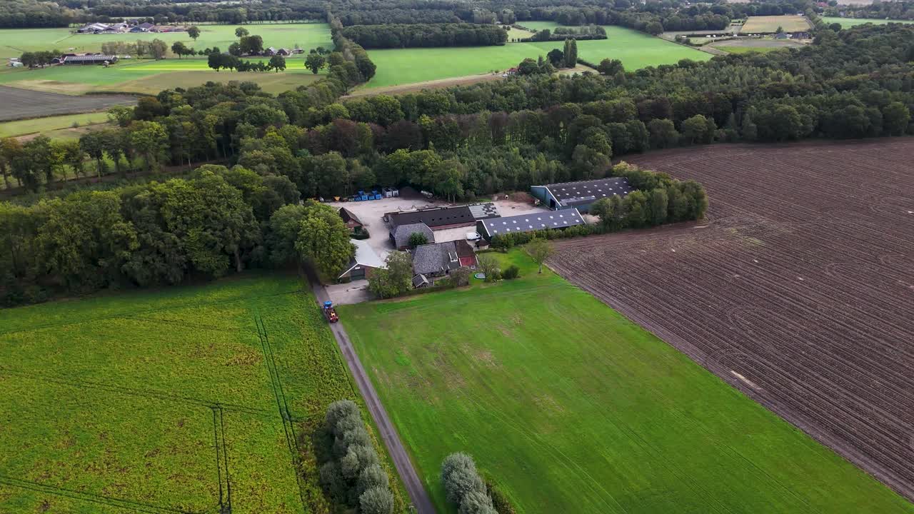 Aerial view of farmland with green fields and crops