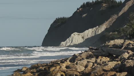 coastal view of waves smashing on rocks near napier, oceanbeach, new zealand