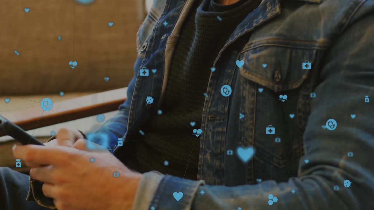 man wearing denim jacket viewing smartphone on sofa, showing floating health icons and data overlay