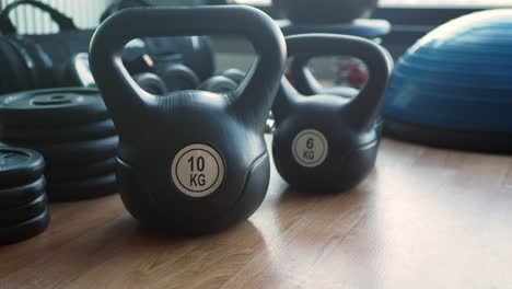 kettlebells and weights on a wooden floor