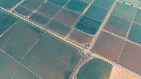 the hon khoi salt fields aerial view, located in nha trang where mounds of natural salt are manually harvested from shallow fields along doc let beach, vietnam