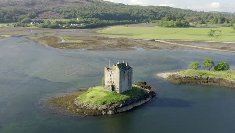 An-aerial,-close-view-of-Castle-Stalker-on-Loch-Laich-on-a-sunny-morning