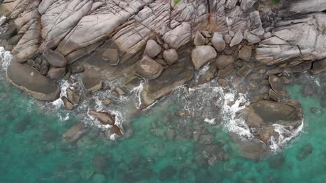 Aerial-view-of-ocean-waves-crashing-on-the-rock-coast-1