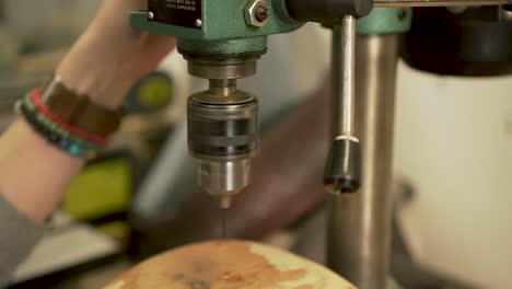 setting up a drill with ratchet, starting up drill machine and checking drill before drilling - slow motion - close up shot