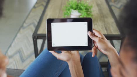 african american mother and daughter using tablet with copy space on screen