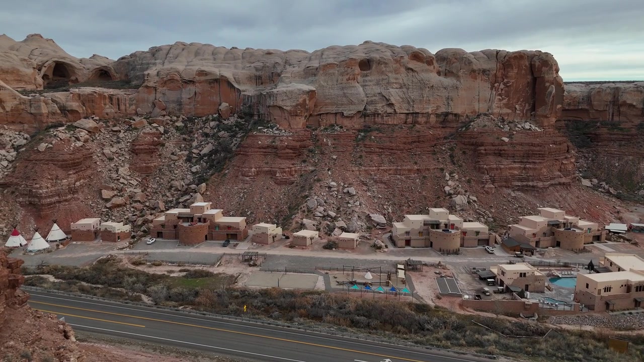 Ripresa con drone di moderni Tipi ed edifici lungo l'autostrada statunitense fuori Bluff, Utah, USA.