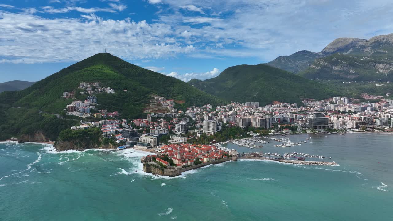 Budva Old Town And City With Mountains In The Adriatic Sea In Montenegro. - aerial shot