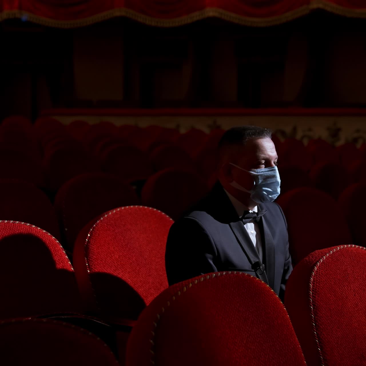 Man in theatre with protection mask