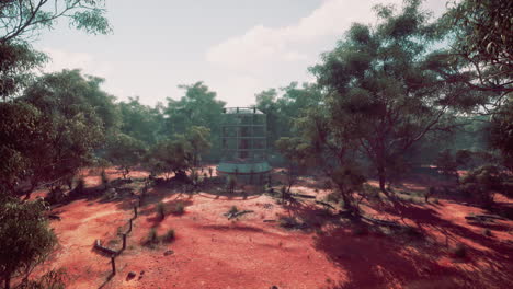 abandoned futuristic tower in a red dirt forest