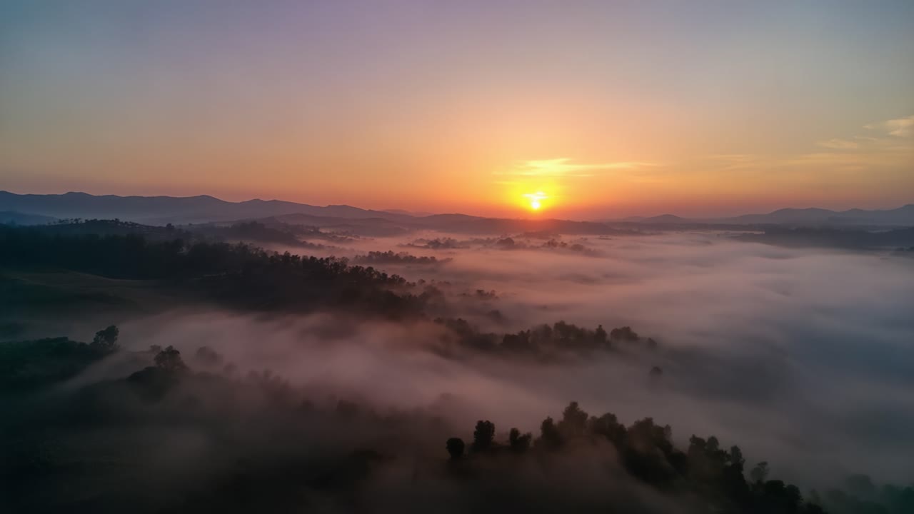 Breathtaking Sunrise Over a Misty Landscape Captured in Two Frames Showing the Serenity of Nature at Dawn with Golden Hues and Soft Fog Covering the Hills