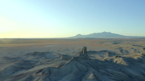 Drone,-aerial-footage-around-moonscape-landscape-near-factory-butte-in-Utah,-United-States