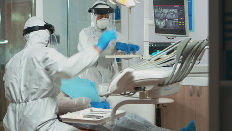 dental technician in protective equipment lighting the lamp