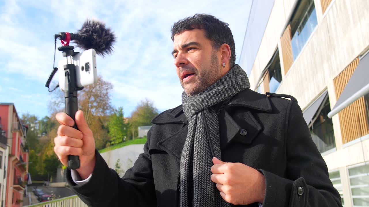 Man Vlogging Outdoors with Smartphone and Microphone