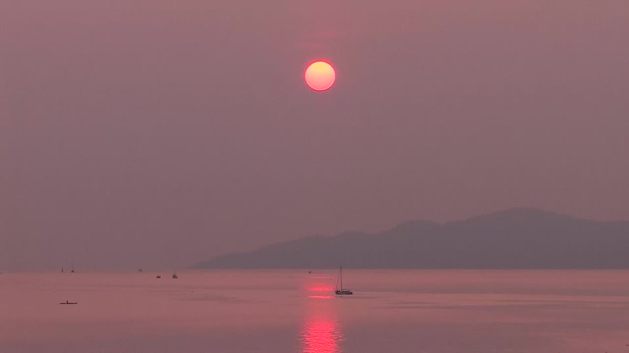 Boat moving through smoke from forest fires