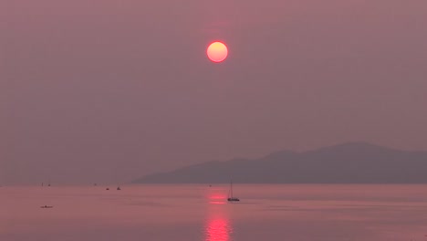 boat moving through smoke from forest fires