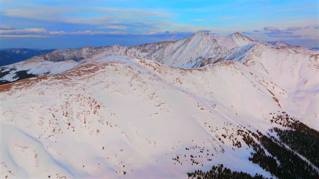 Loveland Pass winter spring golden hour sunset 14er Grays and Torreys Peak Colorado aerial drone panorama landscape Arapahoe Basin backcountry deep powder snow Rocky Mountains forward pan up motion