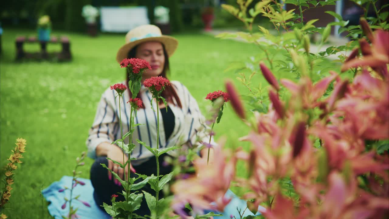 Woman meditating in a serene garden surrounded by vibrant flowers and lush greenery
