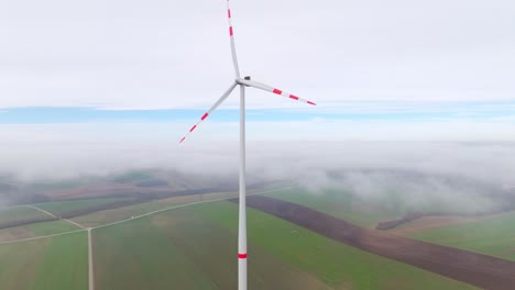 Wind-Turbine-With-Red-Stripes-On-Blades-On-Misty-Morning-In-The-Wind-Farm