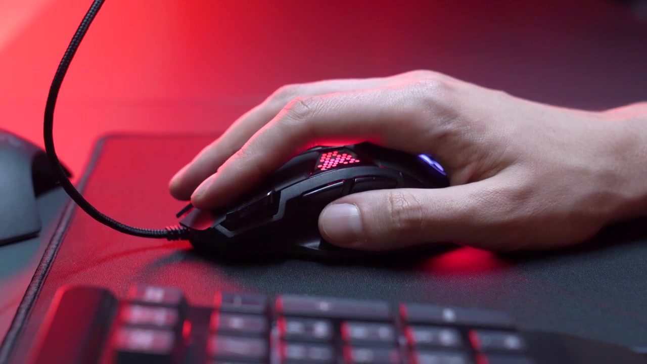 Close-up of Hand Clicking Gaming Mouse with RGB Lighting