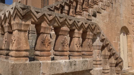 the camera sees the magnificent building of the mor behnam church, one of the most important church of mardin, and the magnificent stone staircase in front of it, tilting it from the bottom up