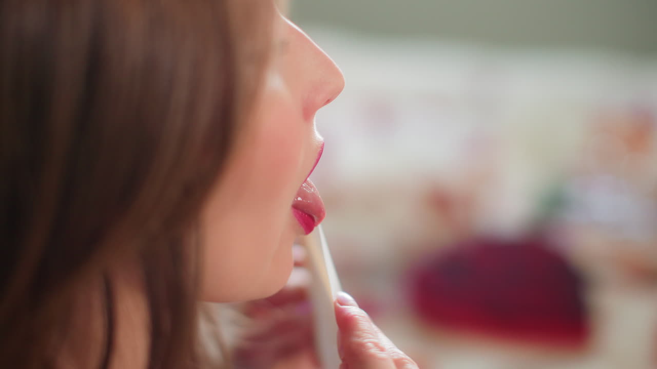 Woman with pink lipstick kisses Valentine's Day card sealed in slow motion