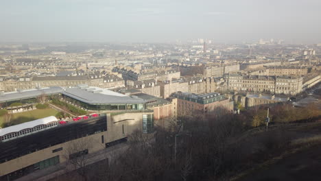 Pan-right-to-left-across-the-north-of-Edinburgh-city-looking-towards-Leith-and-Newhaven-on-a-sunny-day,-Scotland