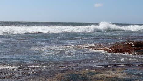 waves crashing onto rocky shoreline