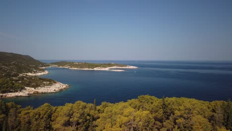 panning view of beaches near vis on the island of vis in croatia and small islands beyond