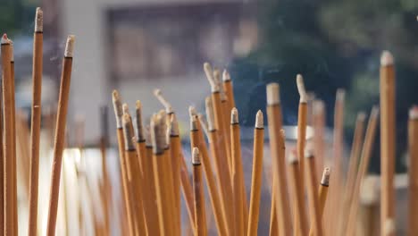 burning incense sticks at a temple