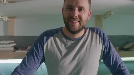 portrait of male surfboard maker in his workshop