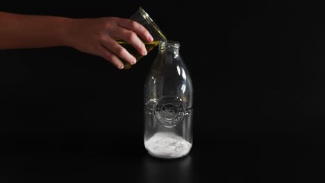 yellow liquid and white powder react in bottle