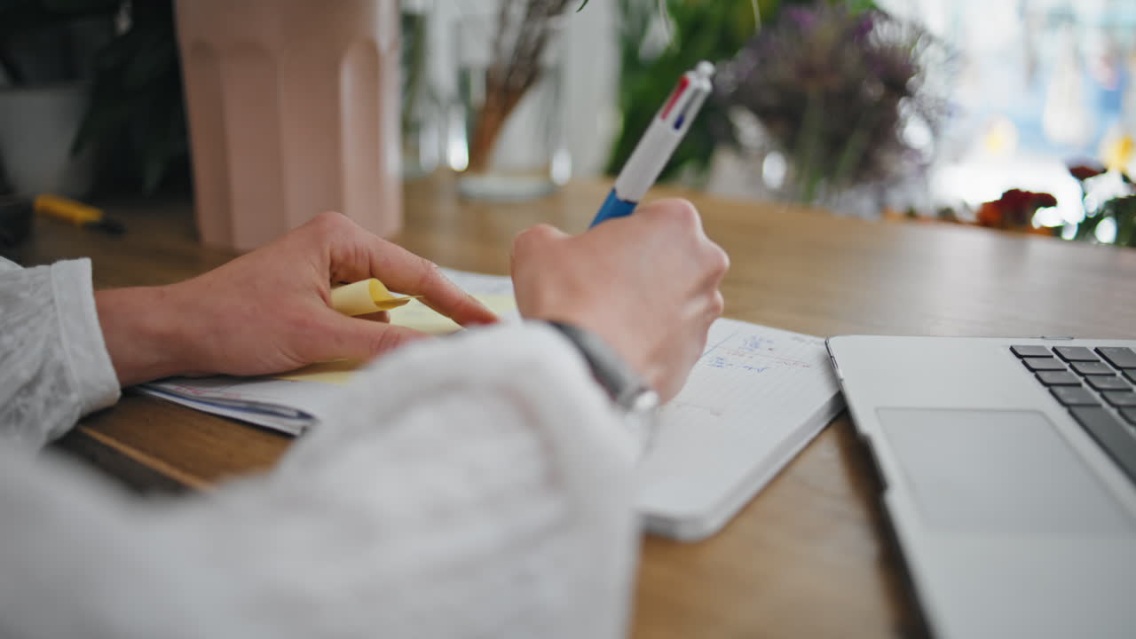 Businesswoman hands write notes stickers on desk. Close up lady create ideas.