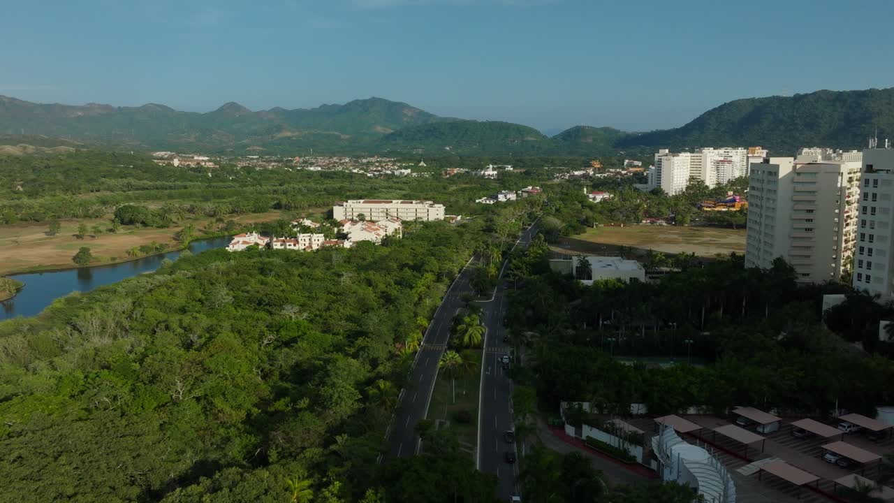 DRONE: DOLLY IN SHOT OF THE MAIN BOULEVARD IN IXTAPA ZIHUATANEJO AT SUNSET