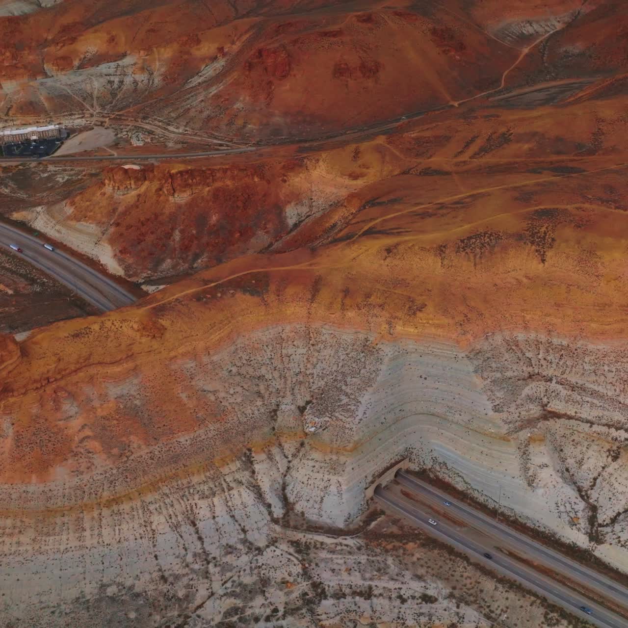 Highway in Wyoming going through the mountain. Little town hiding in the bare rocks. Aerial view