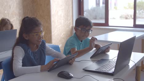 positive school children in glasses doing task