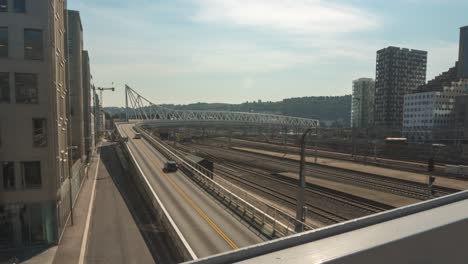 busy commuter road traffic and trains in oslo city centre, time lapse