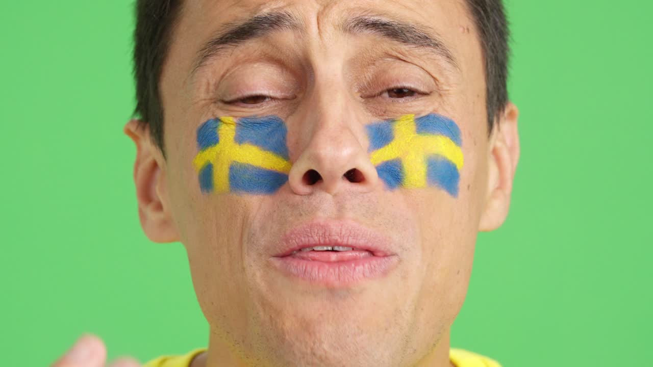 Very nervous man supporting swedish team during a difficult match