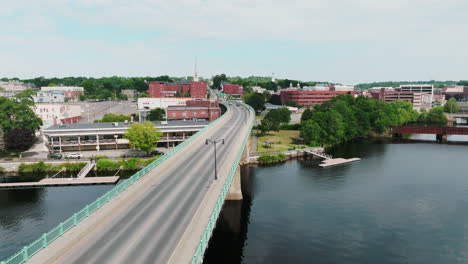 Aerial-Shot-Tracks-Along-Bridge-Towards-Bangor,-Maine-Offering-Spectacular-City-Views