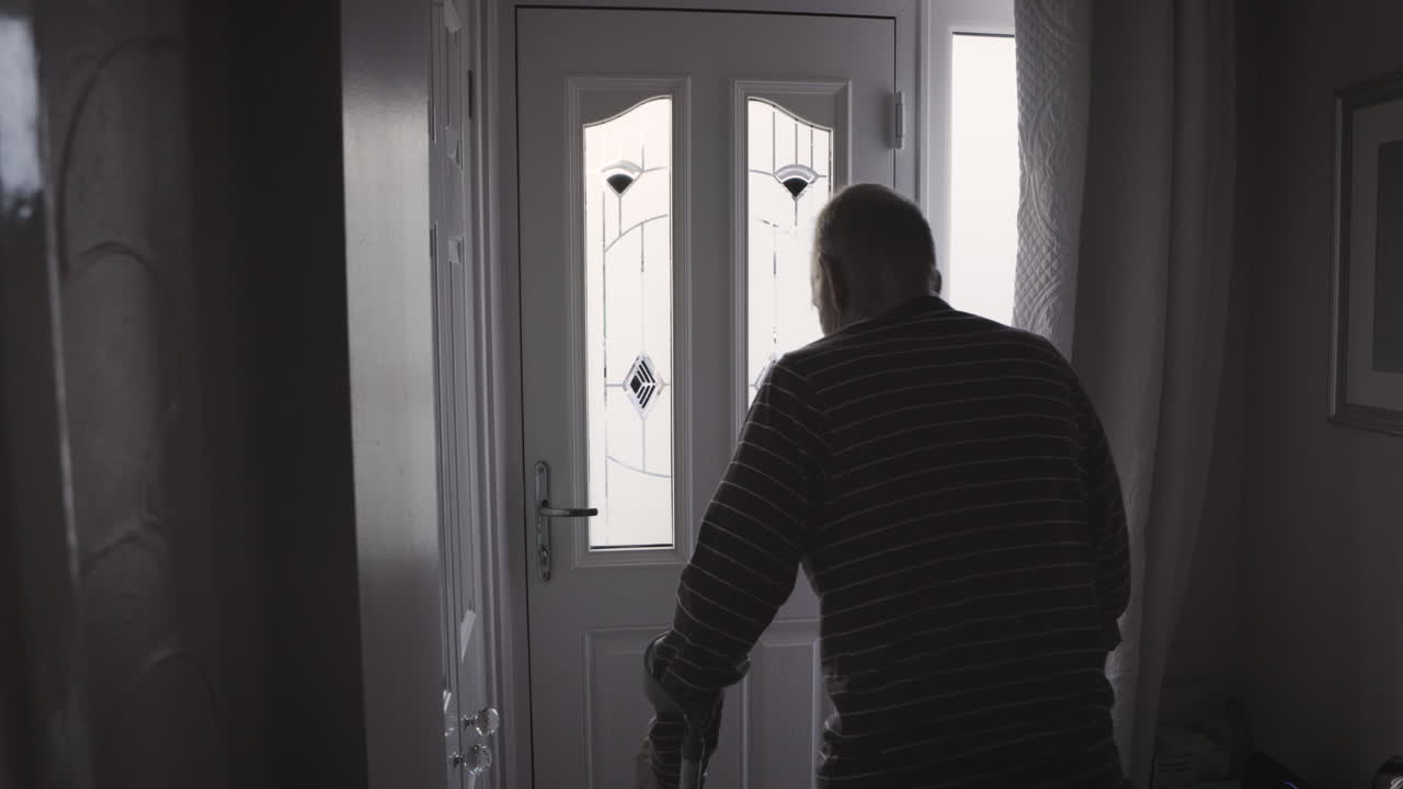 Man standing in a hallway near a door